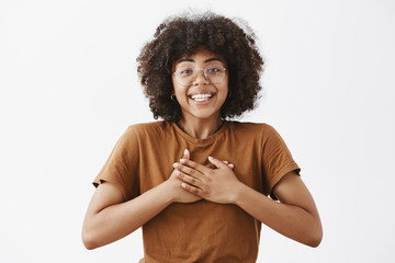 Wall Mural - african american girl appreciate friend support being touched with kind words holding hands on heart