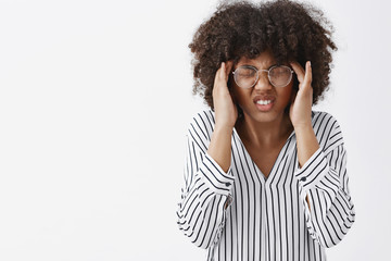 Wall Mural - concerned dark-skinned woman feeling discomfort cannot focus from headache or remember important inf