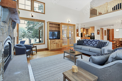 Chic Living Space With High Vaulted Ceiling And Stone