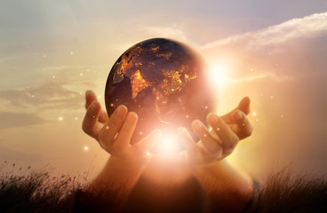 Earth at night was holding in human hands. Earth day. Energy saving concept