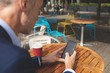 © Wavebreak Media - Businessman using mobile phone at outdoor cafe