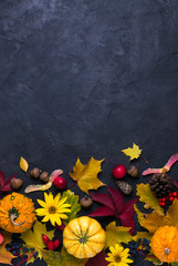  Autumn composition. Frame made of different multicolor dried leaves and pumpkin on dark background. Autumn, fall concept. Flat lay, top view, copy space