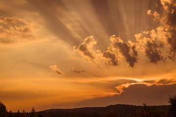 Wall Mural - sunset with rays lighten up the clouds