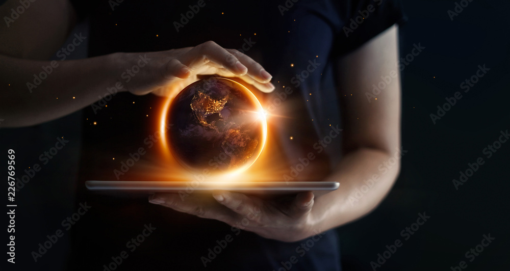Earth at night was holding in human hands and technology. Earth day. Energy saving concept, Elements of this image furnished by NASA - obrazy, fototapety, plakaty 