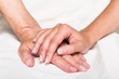 © BillionPhotos.com - Young Woman's Hand Touching an Old Woman's Hand