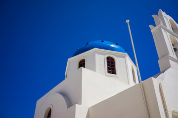 A church in Oia, Santorini, Greece set against a deep blue sky