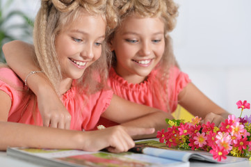 two adorable twin sisters with modern hairstyles 