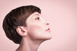 © Solarisys - Beautiful woman. Female face close up. Portrait of young caucasian woman at studio isolated on pastel. Fresh skin and beauty concept. Short haircut, long neck, perfect skin. Profile
