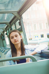 Wall Mural - Beautiful girl rides a tourist bus. Vertical photo.