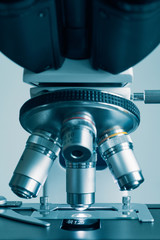 Wall Mural - close-up shot of modern microscope with sample slide at laboratory.