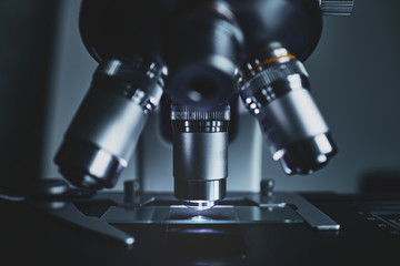 Wall Mural - close-up shot of modern microscope with sample slide at laboratory.