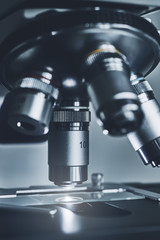 Wall Mural - close-up shot of modern microscope with sample slide at laboratory.
