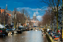 Canals, Boats And Beautiful Architecture At The Old Central District In Amsterdam