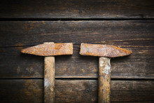 Close Up Of Two Old Used Hammer On A Rustic Wooden Background. Selective Focus