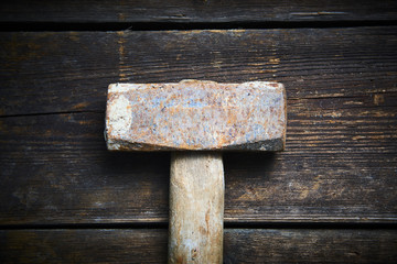 Wall Mural - Close up of old used hammer on a rustic wooden background. Selective focus