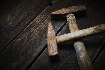 Close up of two old used hammer on a rustic wooden background. Selective focus