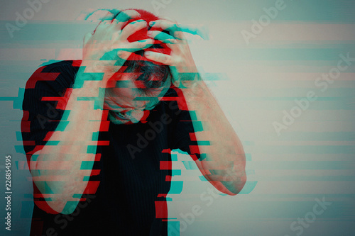Fotografie, Obraz one sad man standing near a wall and covers his face