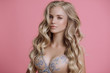 Leinwandbild Motiv blonde girl posing in lingerie on pink background