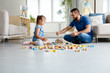 © Snapic.PhotoProduct - Father with daughter playing together at home