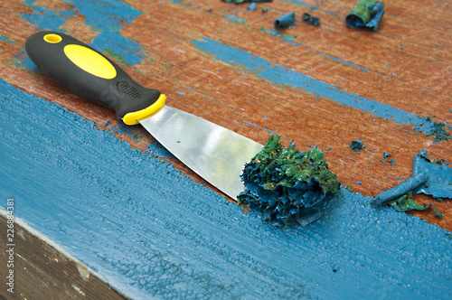 Fotografía renovation furniture - removing blue painting with spatula