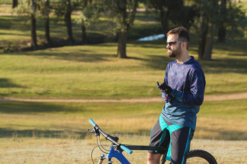 Cyclist in shorts and jersey on a modern carbon hardtail bike with an air suspension fork	