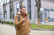© Africa Studio - Young man in warm clothes using cell phone outdoors