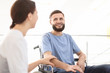 © Africa Studio - Young female doctor taking care of man in wheelchair indoors