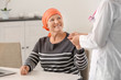 © Africa Studio - Mature woman with cancer visiting doctor in hospital
