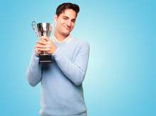 Young Handsome Tanned Man With A Trophy