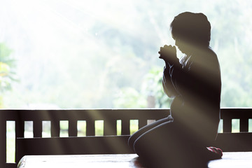 Wall Mural - Young girl praying with holy bible in the morning. Woman praying to god. Christianity concept. Pray concept. Faith hope love concept.