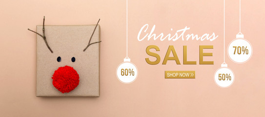 Wall Mural - Christmas sale message with a red nose reindeer gift box