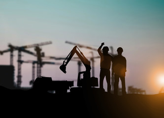 Wall Mural - Silhouette of engineer and construction team working at site over blurred background for industry background with Light fair.Create from multiple reference images together
