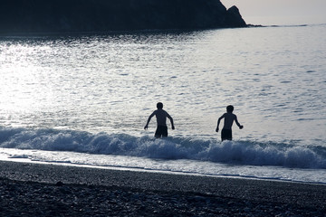 two men go to the shore to swim in the sea