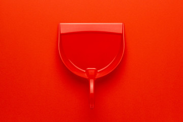 top view of plastic dustpan on red background