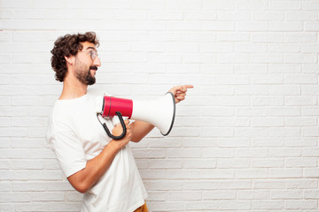 young dumb man smiling and pointing upwards with both hands, towards the place where the publicist may show a concept.