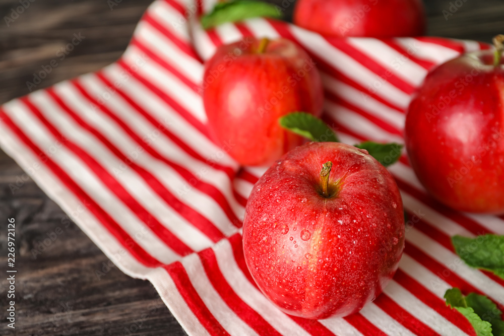 Fresh red apples on wooden table