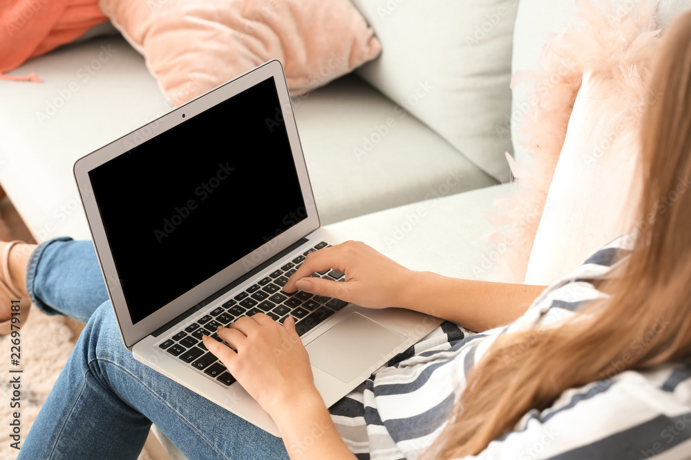 Young woman working on laptop at home
