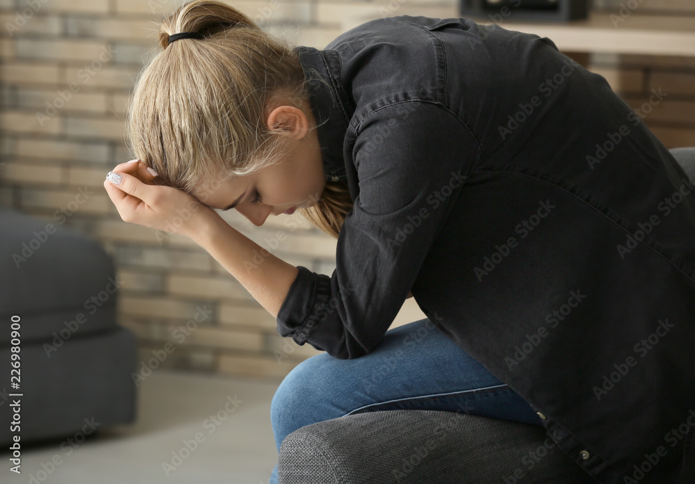 Lonely woman suffering from depression at home