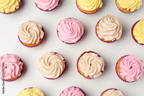 Fotografía Delicious cupcakes on white background, flat lay