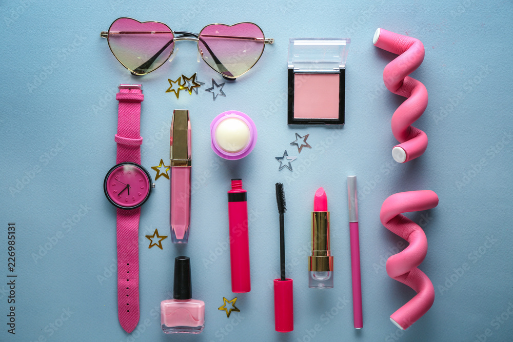 Set of decorative cosmetics with accessories on color background