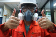 Multi-purpose respirator half mask for toxic gas protection.The man prepare to wear Multi-purpose half mask for measure toxic gas.