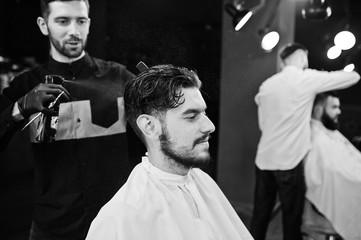 Wall Mural - Handsome bearded man at the barbershop, barber at work.