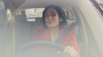 Wall Mural - Portrait of Beautiful Young Woman Driving Car through Sunny Suburban Area. Camera Shot Made From the Front Windshield.