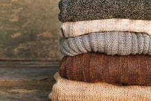     Pile Of Colorful Warm Clothes On Wooden Background.