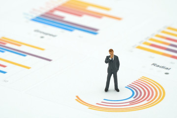 Miniature people businessmen analyze standing on Circle graph with performance as background strategy concept and Business concept with copy space.