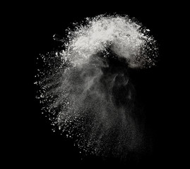 White powder or flour explosion isolated on black background  freeze stop motion object design