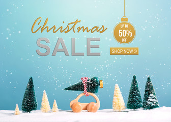 Wall Mural - Christmas sale message with little car carrying a Christmas tree