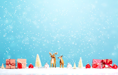 Wall Mural - Reindeer and Christmas gifts in snowy day