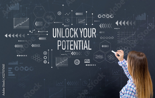 Fotografie, Obraz Unlock your potential with young woman writing on a blackboard