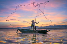 Fishermen Fishing In The Early Morning Golden Light.Fishermen On A Fishing Boat